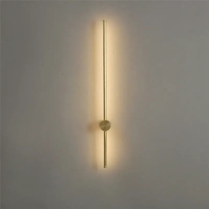 Gold-toned minimalist led wall lamps by decorbites with sleek vertical rod and warm ambient light for modern living room decor