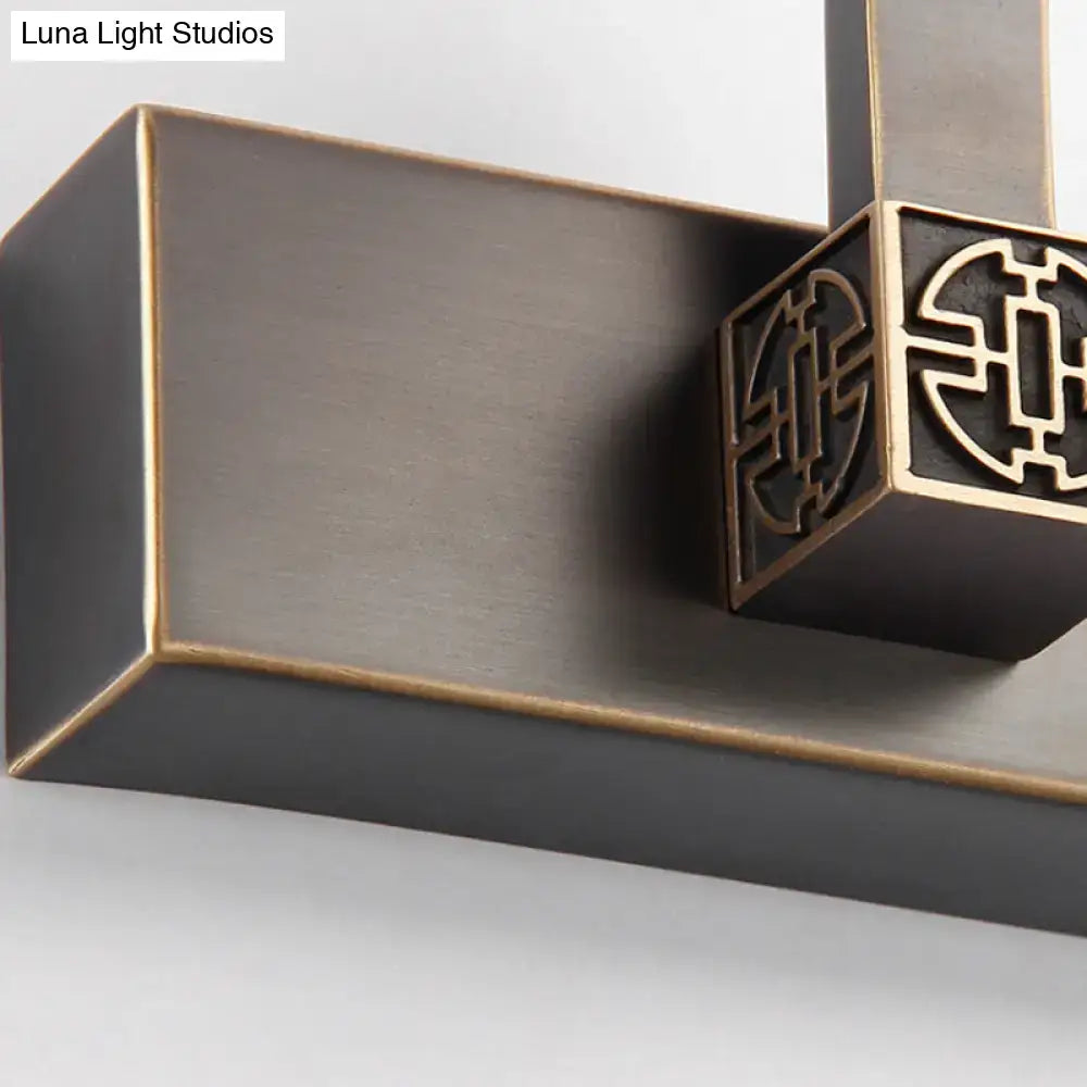 Modern black and gold led wall light bronze finish with intricate geometric cutout detailing and bulb base for bathroom vanity