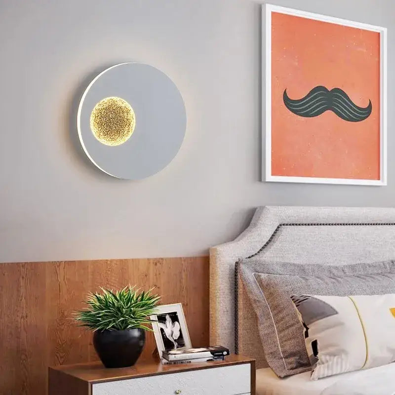 Modern black and gold led wall lights circular sconce with sleek gray finish and glowing golden textured center by decorbites
