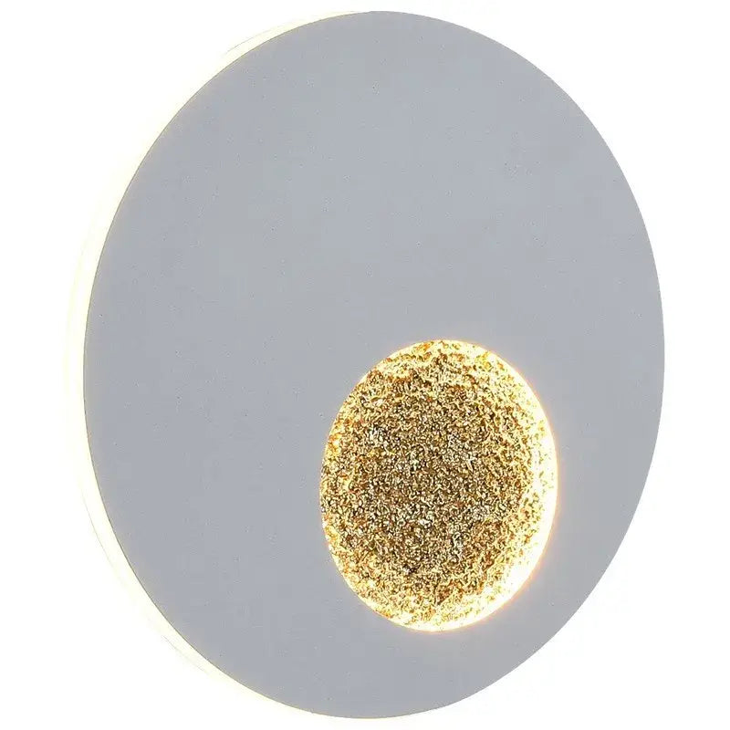 Modern black and gold led wall lights feature a circular matte gray ring with a textured illuminated gold center