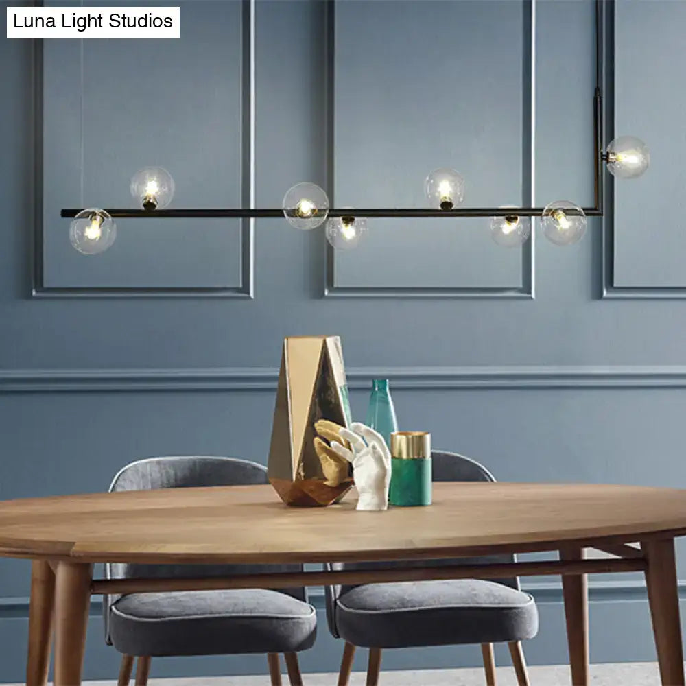 Modern black gold linear chandelier with six clear glass globe bulbs for dining room or kitchen island lighting