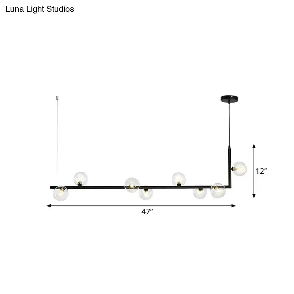 Modern black gold linear chandelier with six clear glass globe bulbs ideal for dining room or kitchen island lighting