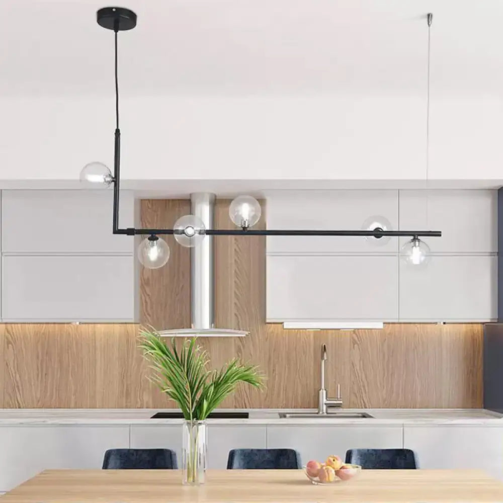 Modern black and gold linear chandelier featuring clear glass globe bulbs for dining room or kitchen island lighting