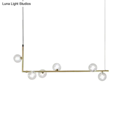 Modern black gold linear chandelier with brass l-shaped frame and five clear glass globe bulbs for dining room island lighting