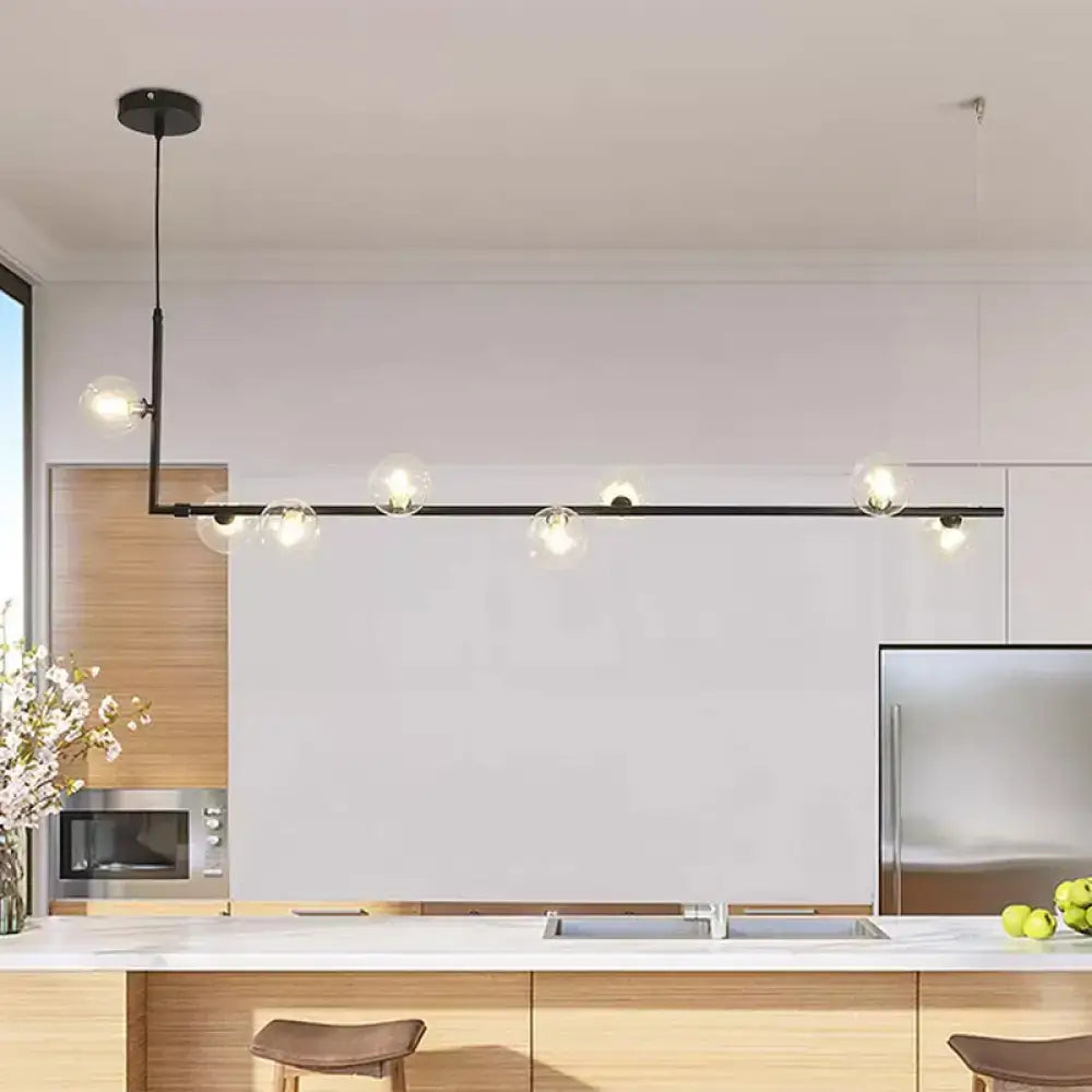Modern black gold linear chandelier with black metal frame and clear glass globe bulbs for dining room island lighting