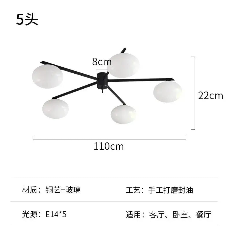 Modern black metal and gold lustre ceiling light fixture with five frosted glass globes for kitchen use