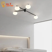 Modern black and gold lustre ceiling light fixture with four frosted glass globes ideal for kitchen lighting