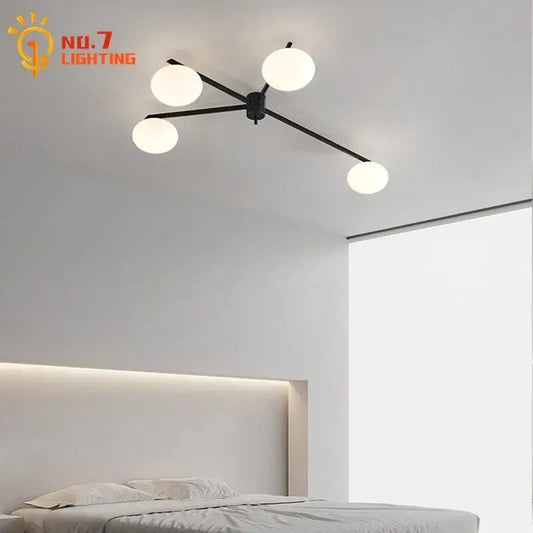 Modern black and gold lustre ceiling light fixture with four frosted glass globes ideal for kitchen lighting