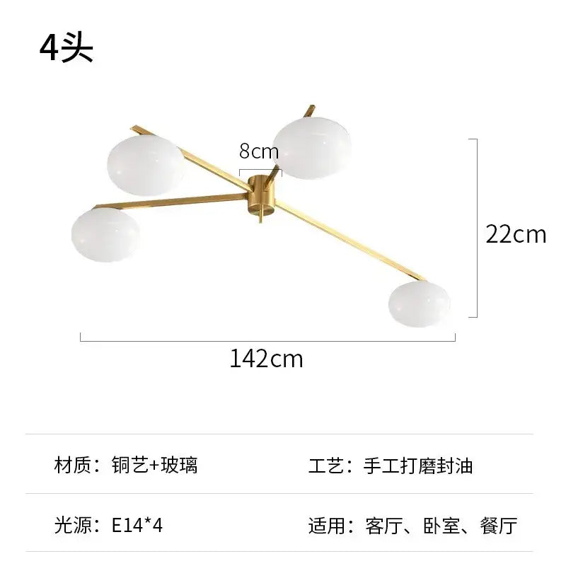 A modern ceiling light fixture with a gold lustre metal frame and white glass globes for kitchen use