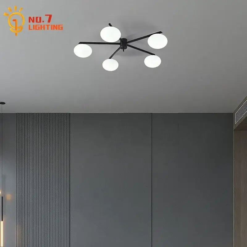 Modern black and gold lustre ceiling light fixture with five frosted white glass globes for kitchen use