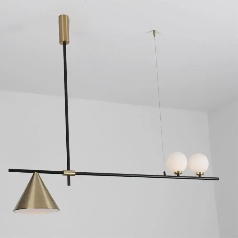 Modern black and gold metal cone island light with a black rod and frosted glass bulbs for dining room use