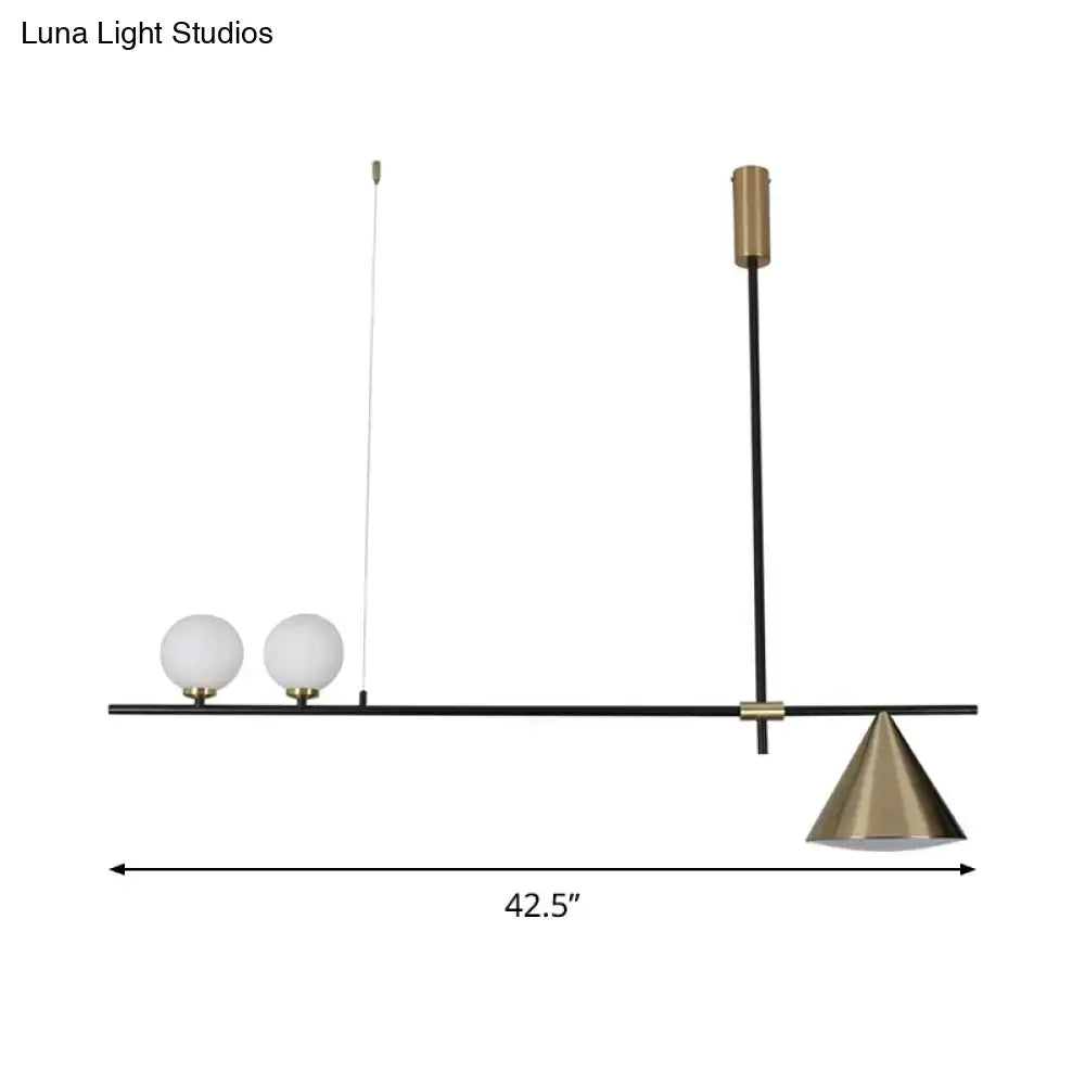 Modern black and gold metal cone island light with spherical glass globes and a brass conical shade for dining room
