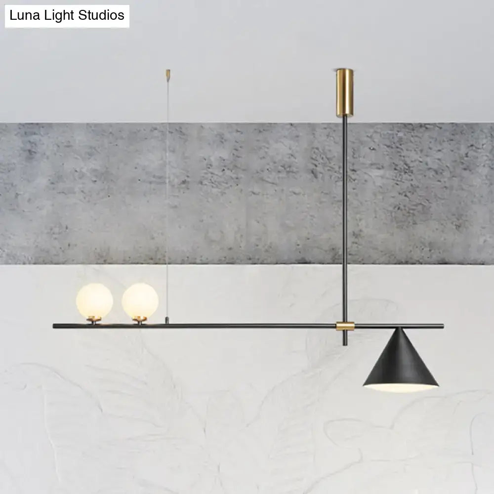 Modern black and gold metal cone island light featuring two spherical glass bulbs and conical shade for dining room