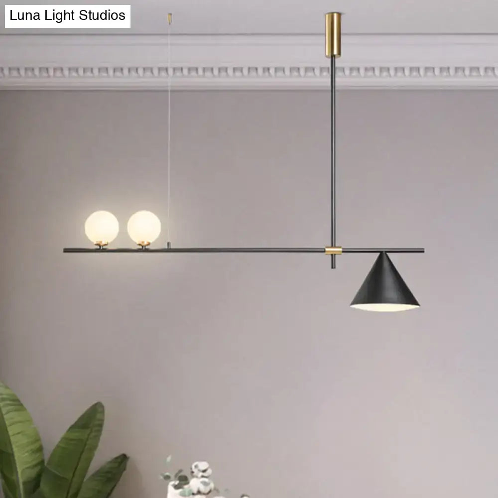 Modern black and gold metal cone island light with brass details and spherical glass bulbs for dining room lighting