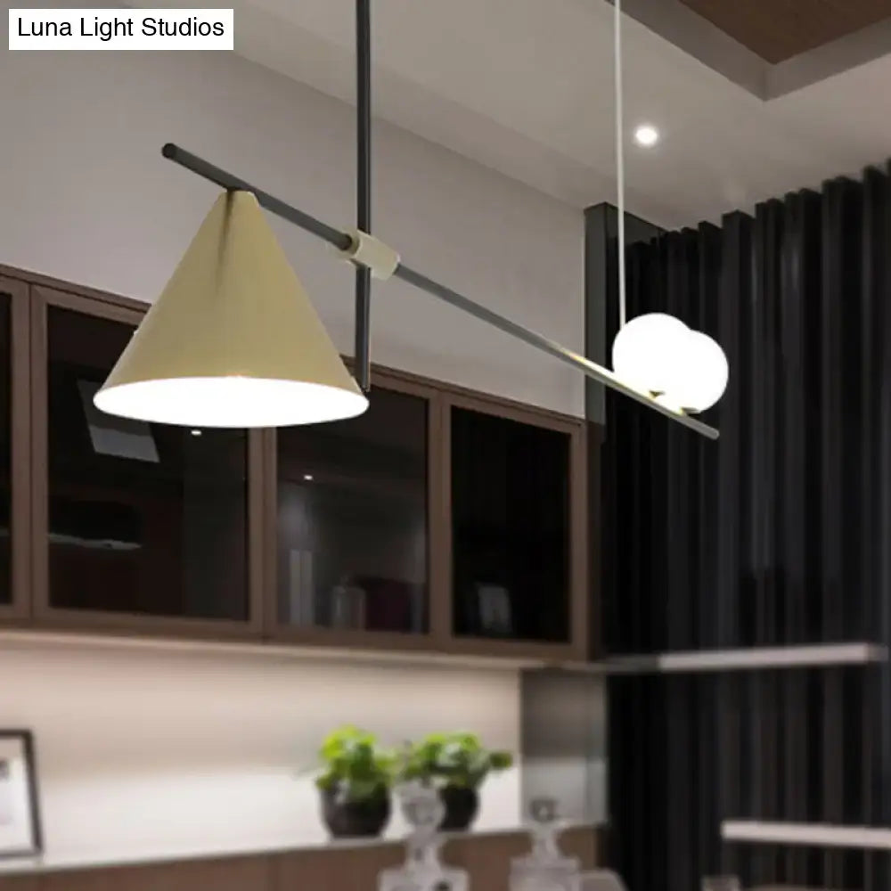 Modern black and gold metal cone island light with beige conical shade and two white spherical bulbs for dining room