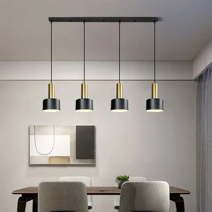 Modern black and gold metal finish pendant light with cylindrical design and brushed nickel accents for kitchen use