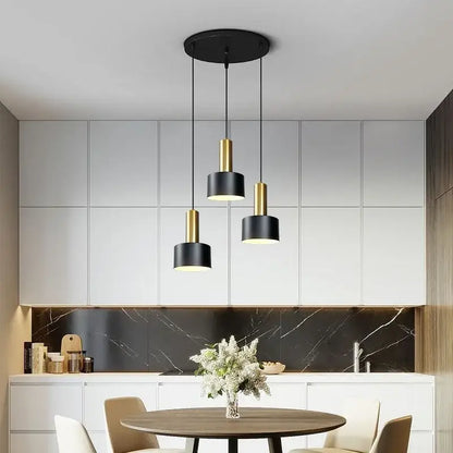 Modern black and gold metal finish pendant light with cylindrical shades and brushed nickel ceiling mount for kitchen use
