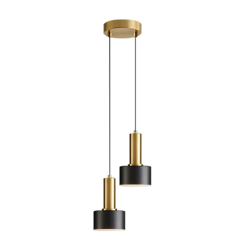Modern pendant light with black and gold metal finish cylindrical shades and brushed nickel ceiling mount for kitchen