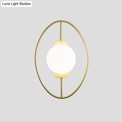 Modern black and gold metal halo ring wall lamp with a gold-toned oval frame and white glass frosted globe wall lamp
