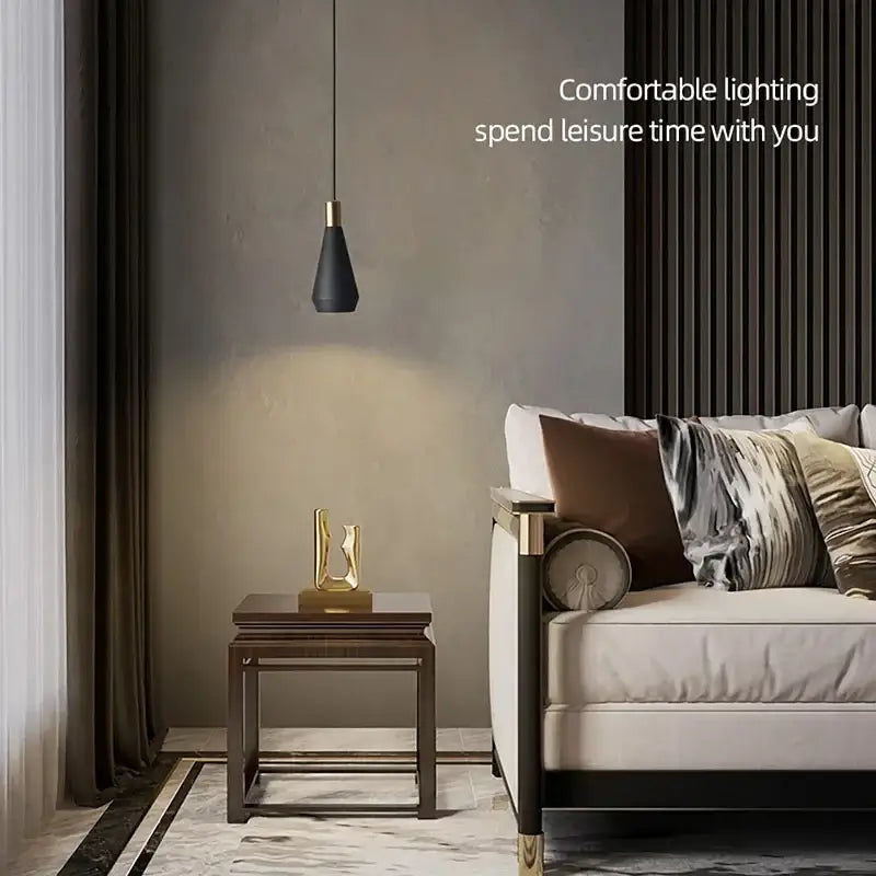 Modern black metal pendant chandelier with gold toned top hanging from thin cord decorbites black metal lighting