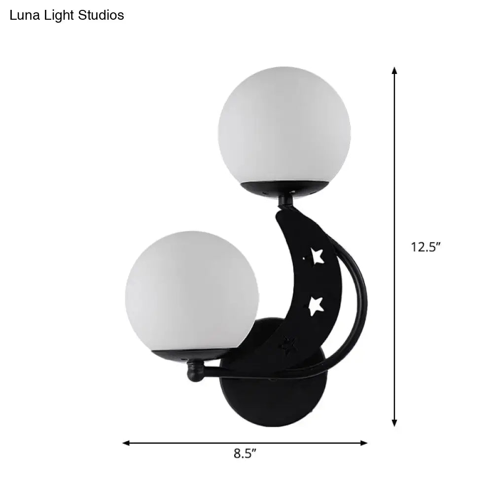 Modern black wall lamp with crescent moon shape, star cutouts, and two milky glass ball shades for bedroom use