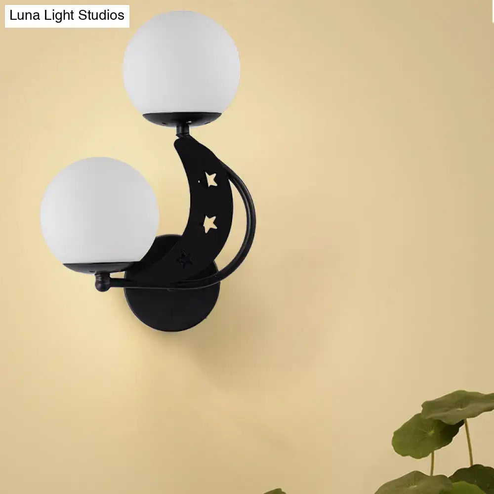 Modern black and gold crescent moon wall lamp with milky glass ball shades and star cutouts for bedroom lighting