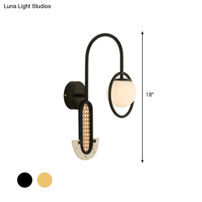 Modern black metal wall sconce with curved arm, opal glass ball shade, textured concrete base, 110v-120v and 220v-240v compatible
