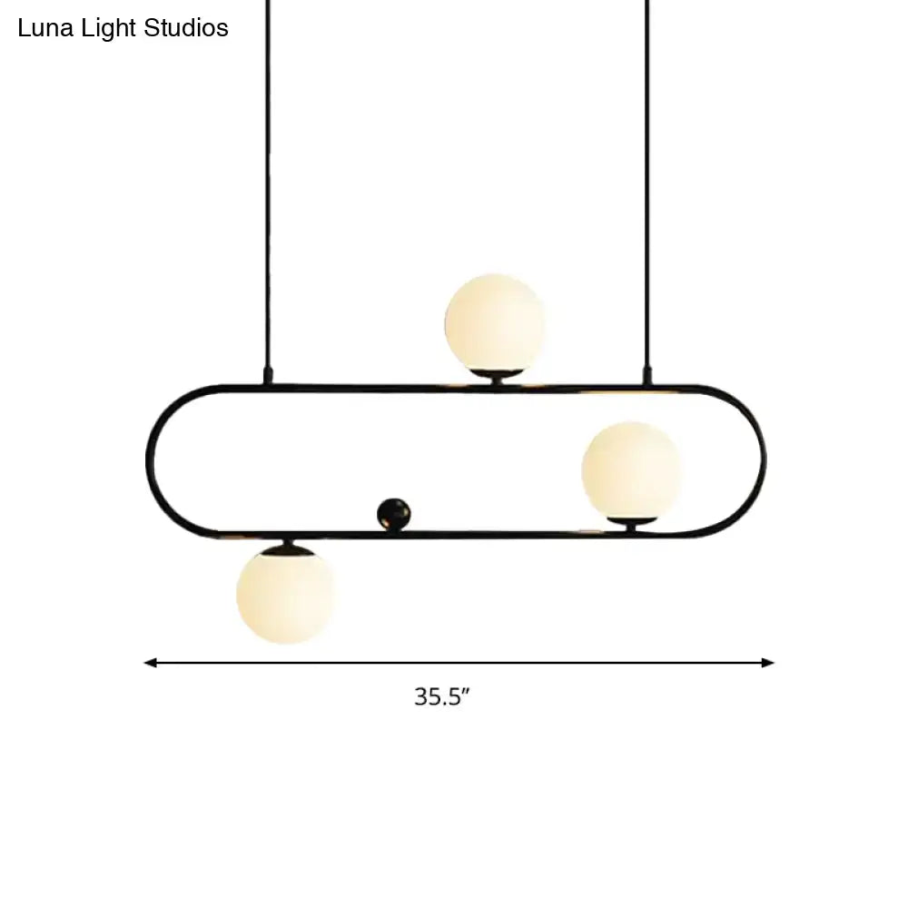 Black metal pendant light with three frosted glass globe bulbs in black gold finish for dining room use
