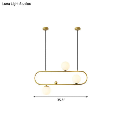 Modern black gold pendant light with three frosted opal glass globes for dining room ceiling or island lighting