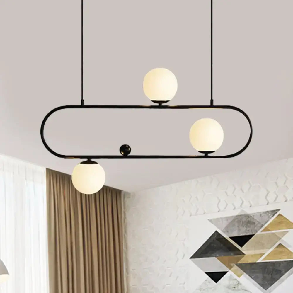 Black metal pendant light with three frosted opal glass globes in black gold finish for dining room use