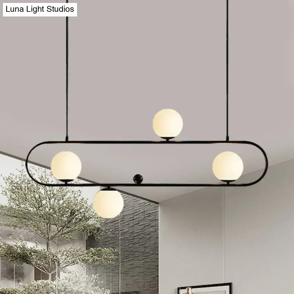Modern black gold metal pendant light with four frosted opal glass globe bulbs for dining room LED or incandescent use