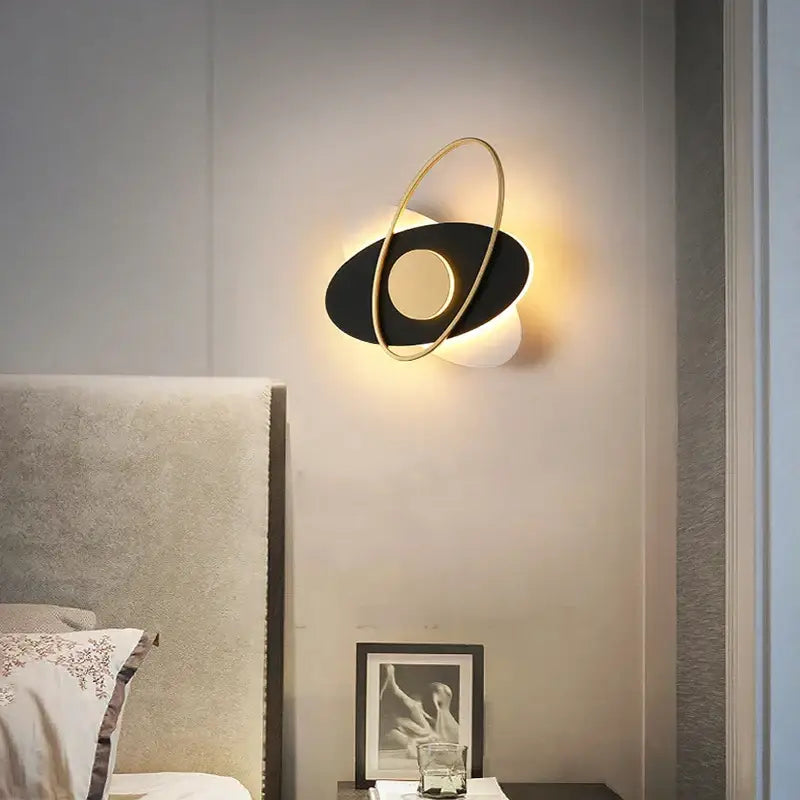 Modern black and gold oval wall sconce light with a sleek minimalist design for living room illumination