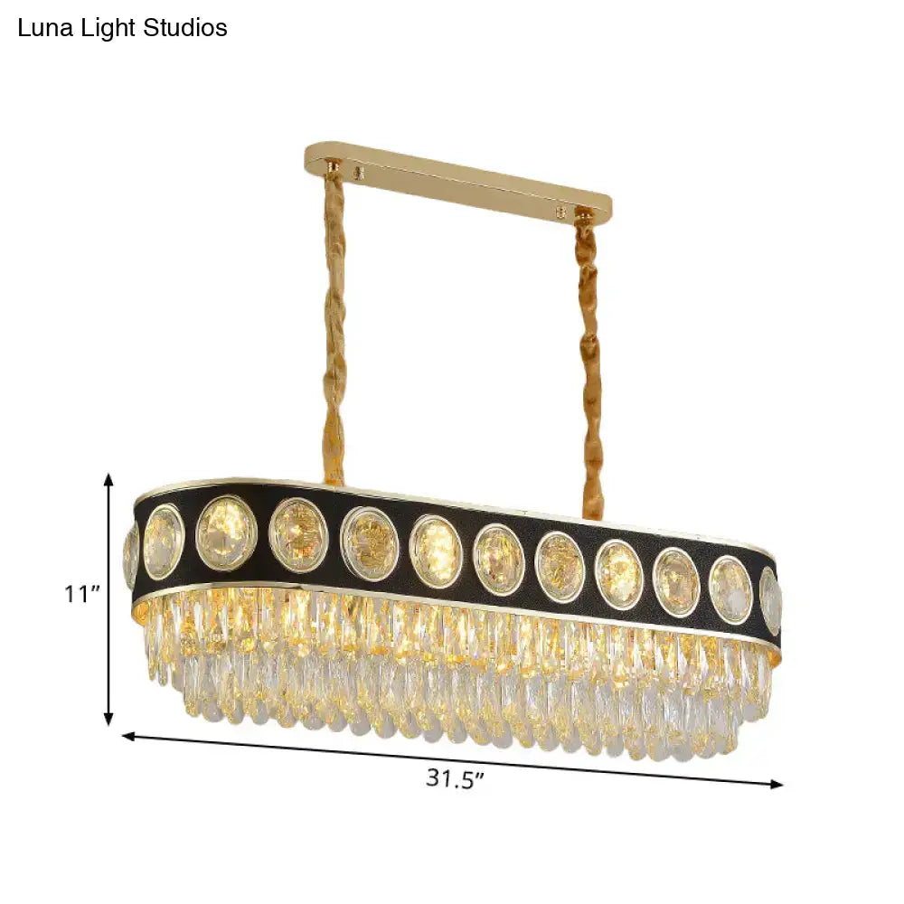 Gold-toned DecorBites™ modern oval island light with black frame, 10 crystal heads, and cascading glass prisms for dining table
