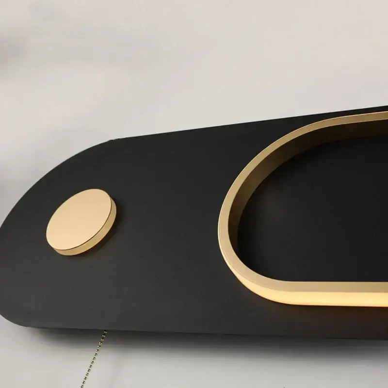 Modern black and gold oval led wall lamp with sleek curved minimalist design for bedroom use