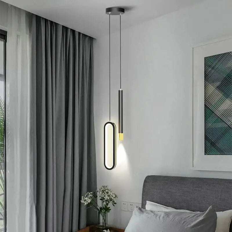 Modern black and gold oval pendant lamps with elongated illuminated frame and sleek minimalist black pendant lamps design