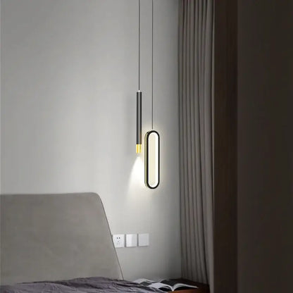 Modern black and gold oval pendant lamps feature a sleek black stem and warm gold base perfect for minimalist lighting