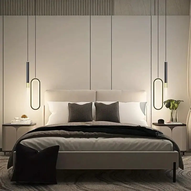 Modern minimalist bed with light gray upholstered headboard and frame under modern black and gold oval pendant light white light source