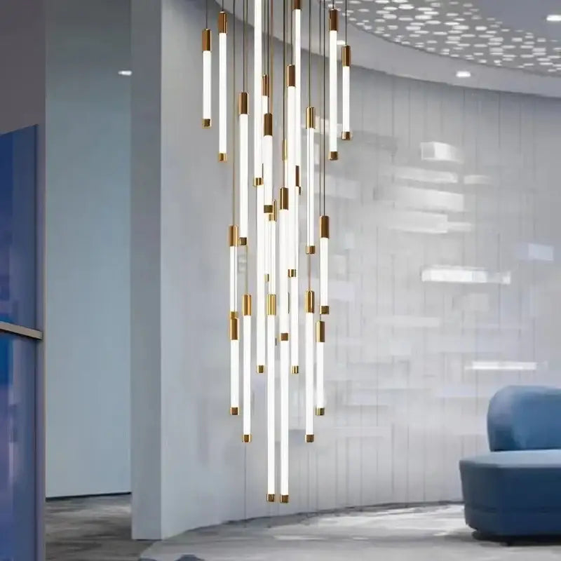 Modern black and gold pendant chandelier with slender white cylindrical light tubes and gold-toned metallic accents