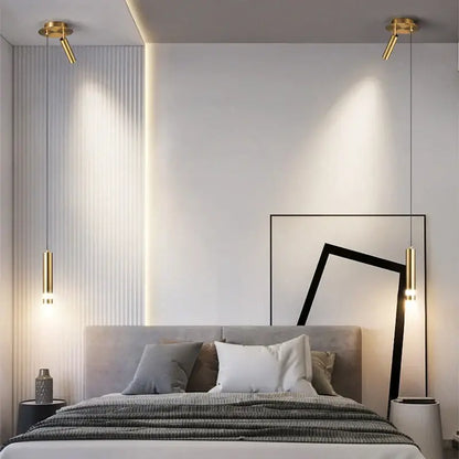 Modern black and gold pendant light with cylindrical shades as light sources enhancing modern interiors in bedroom