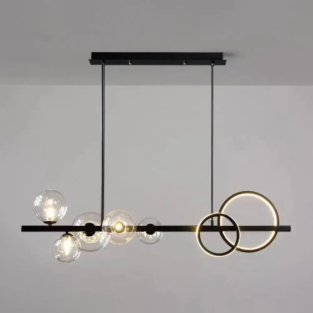 Modern black metal and gold pendant light with clear glass globe bulbs for dining room illumination