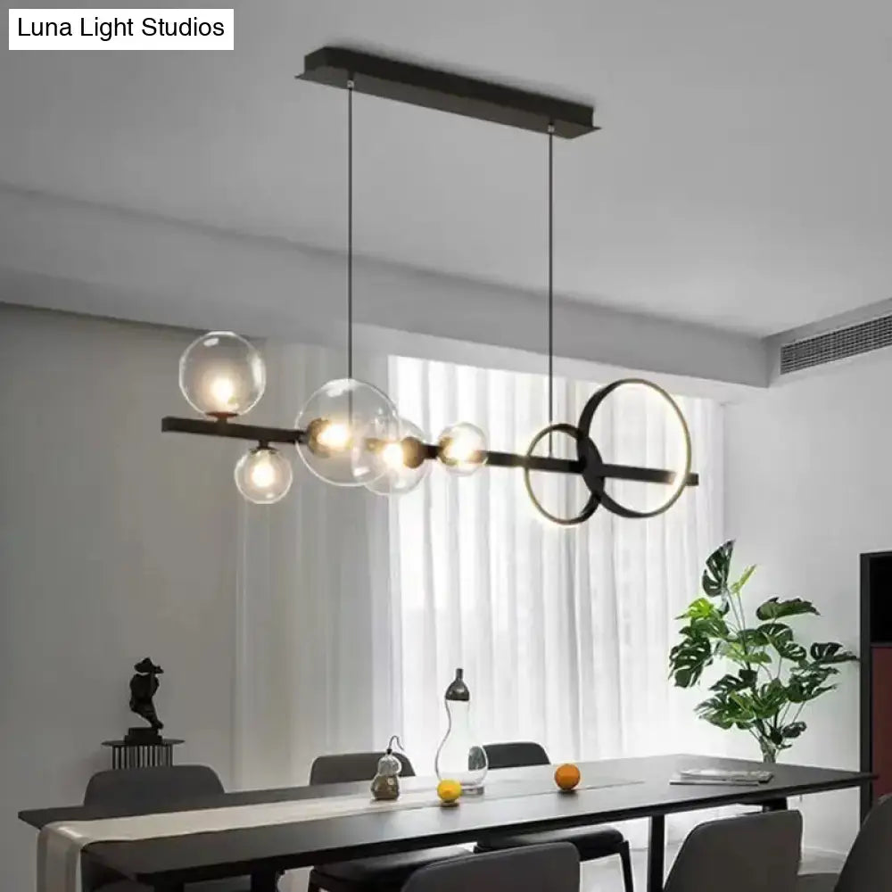 Modern black metal chandelier with clear glass globe bulbs and circular accents for dining room lighting