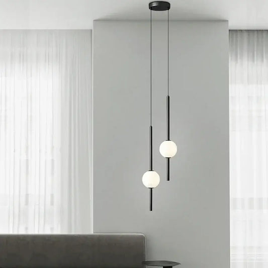 Modern black and gold pendant light with spherical frosted glass shades for elegant living room decorbites gold pendant