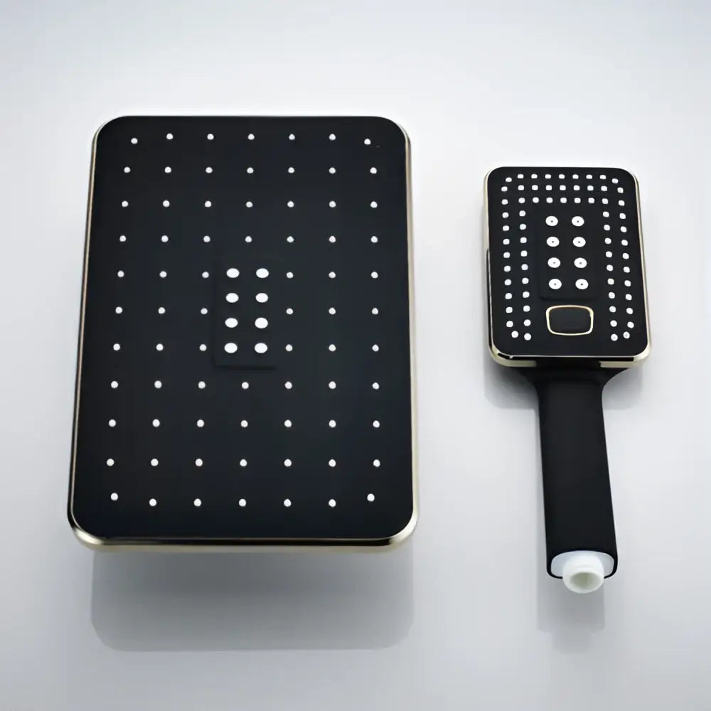 Modern black and gold rainfall shower head with grid nozzles paired with matching handheld black rainfall shower unit