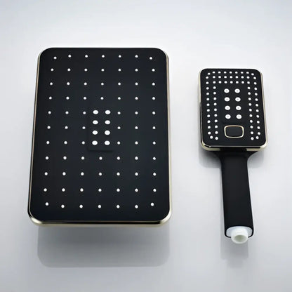 Modern black and gold rainfall shower head with grid nozzles paired with matching handheld black rainfall shower unit
