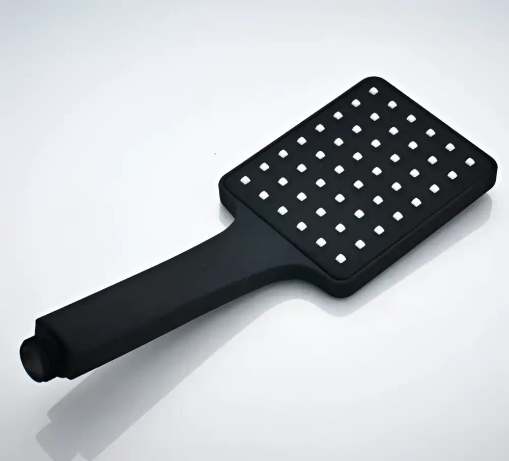 Black rainfall shower head with matte finish and evenly spaced square perforations for modern bathroom use