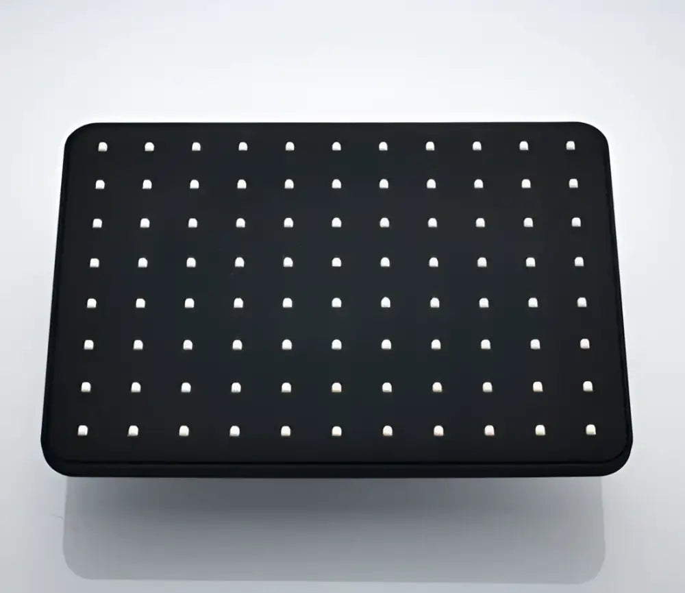 Black rectangular pegboard with evenly spaced white holes as a back panel for modern black rainfall shower head bathroom handshower