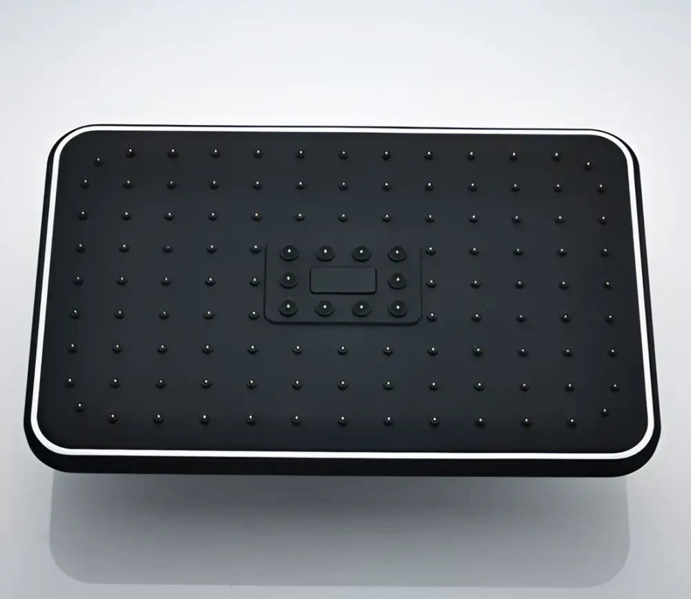 Black rectangular rainfall shower head with grid nozzles and central control panel for modern bathroom use