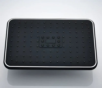 Black rectangular rainfall shower head with grid nozzles and central control panel for modern bathroom use