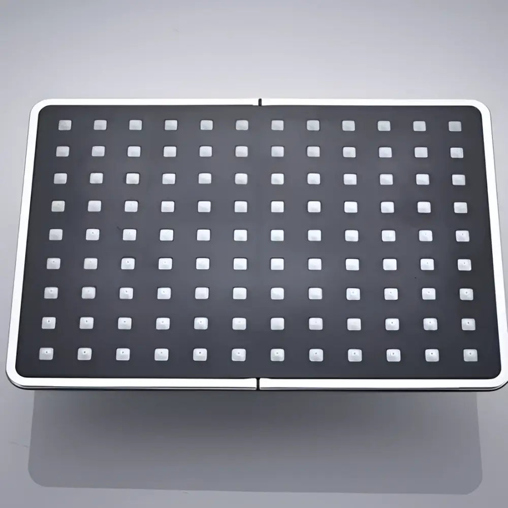 Modern black rainfall shower head with white square nozzles and sleek silver metallic frame for bathroom use