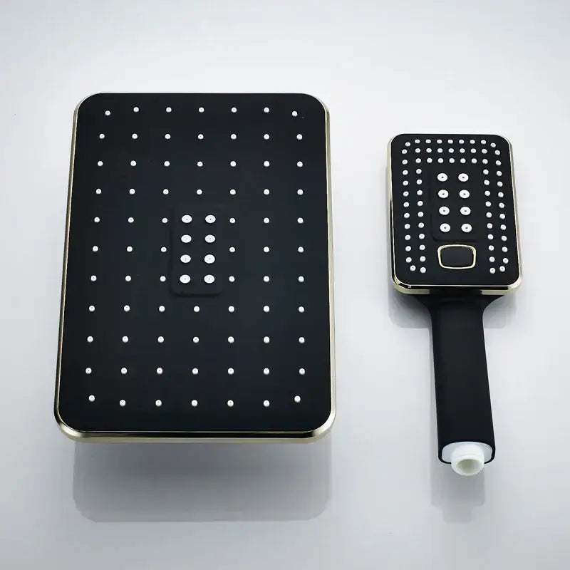 Modern black and gold rainfall shower head set with rectangular rainhead and handheld unit featuring dotted spray patterns